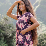 woman wearing dark purple maxi dress with orchid print