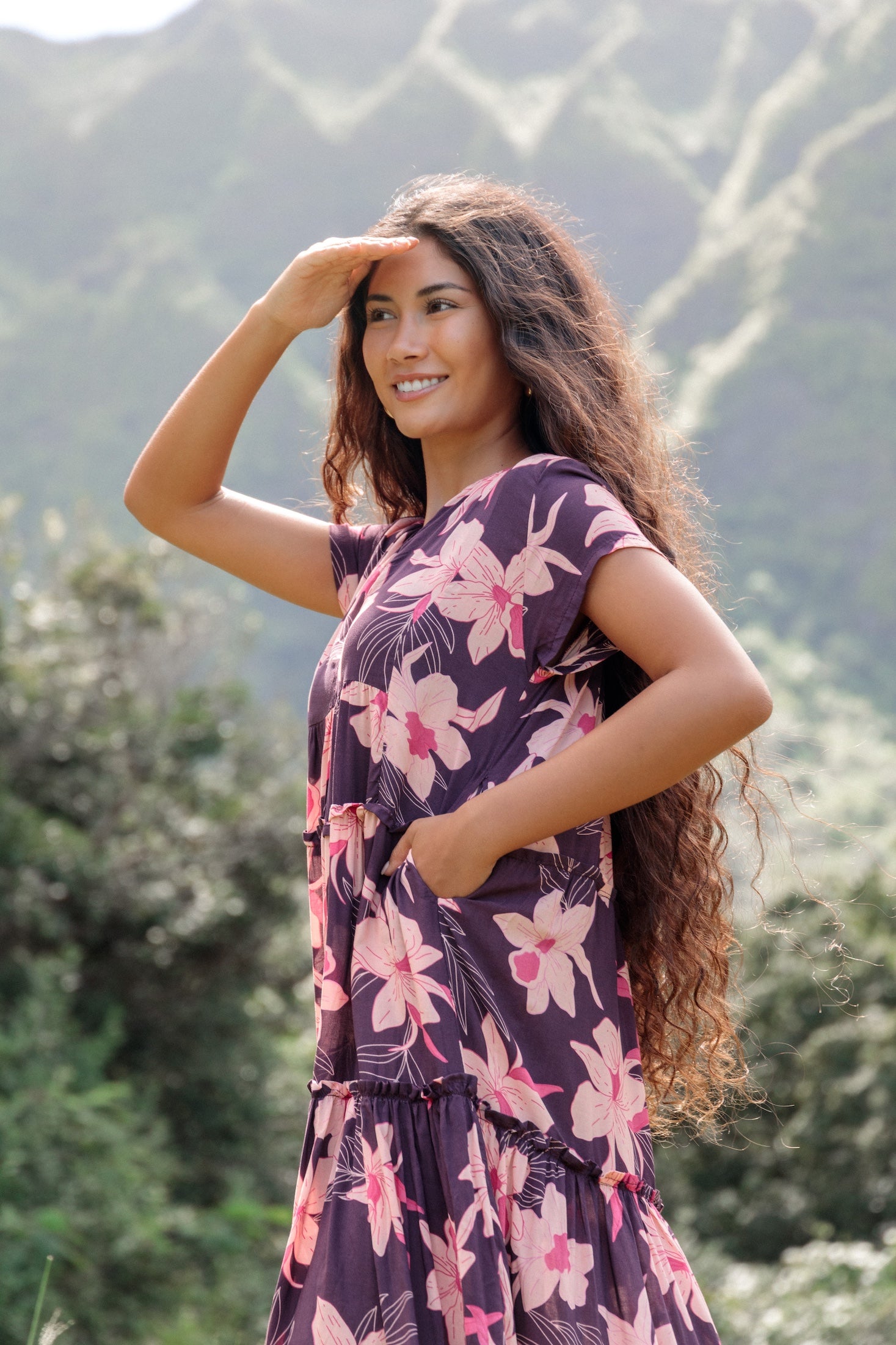 woman wearing dark purple maxi dress with orchid print