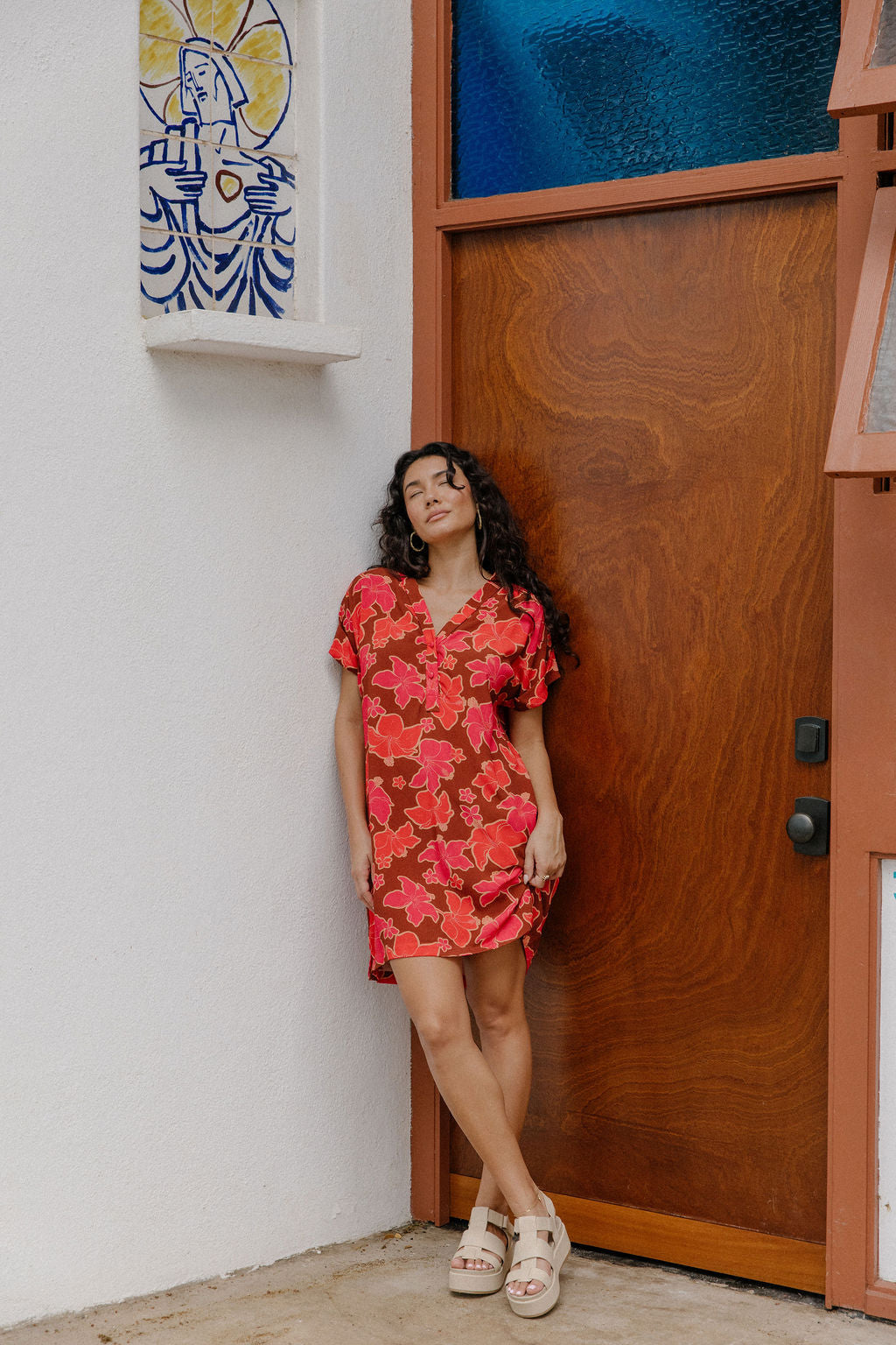 woman with brown hair wearing a half button v neck dress with retro pink pua print