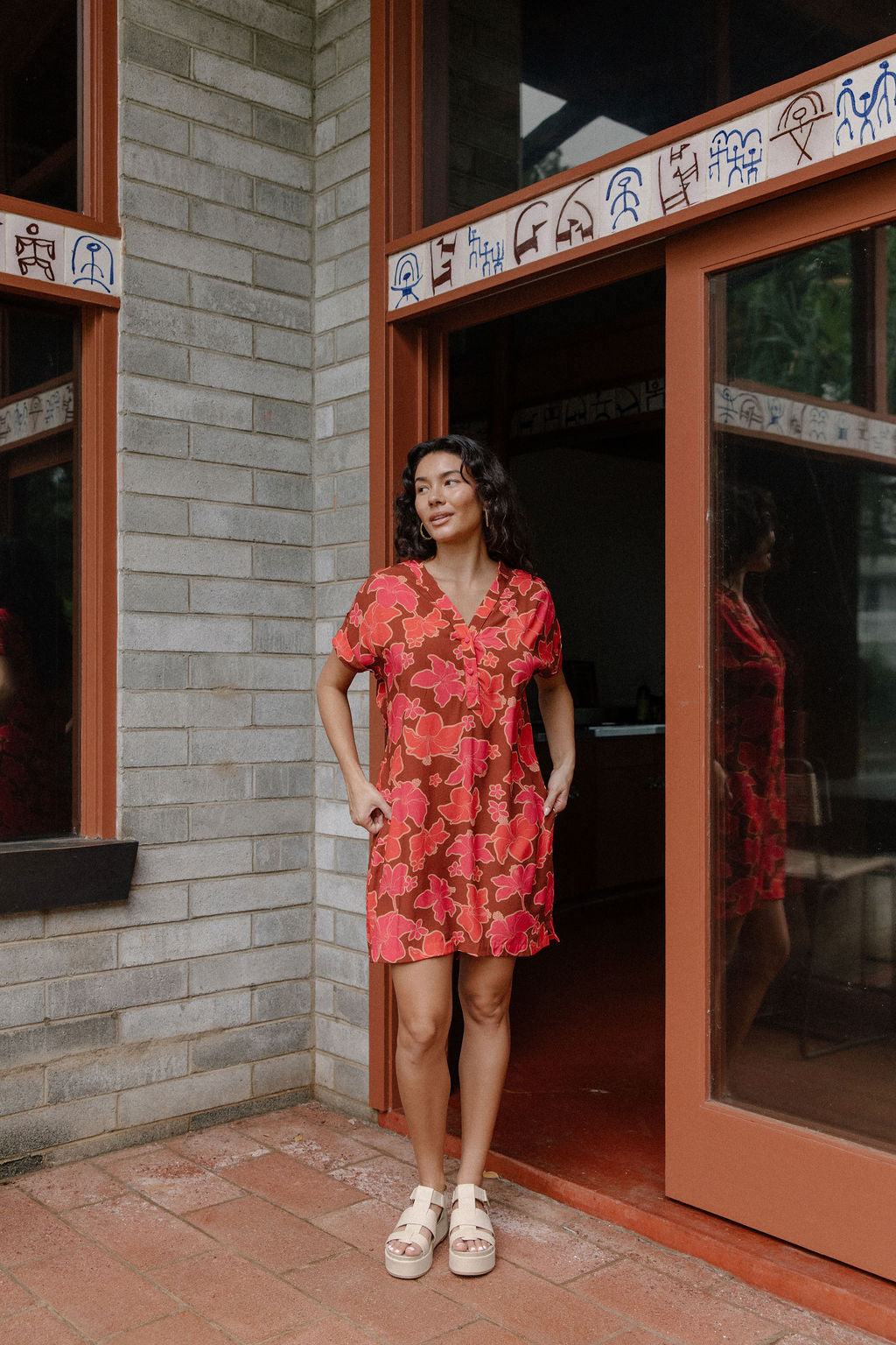 woman with brown hair wearing a half button v neck dress with retro pink pua print