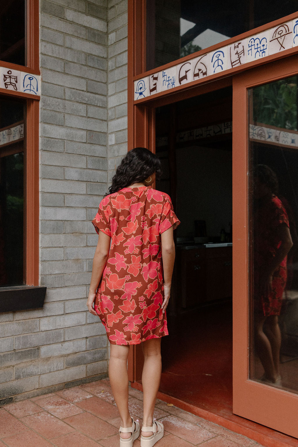woman with brown hair wearing a half button v neck dress with retro pink pua print