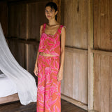 A woman with dark hair wears a YIREH wide legged pant with elastic waistband. It is the Elodi Pant in the Garden 'Awapuhi print. 