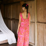 A woman with dark hair wears a YIREH flowy cropped top. It is the Naia Top in the Garden 'Awapuhi print. 