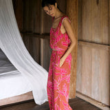 A woman with dark hair wears a YIREH wide legged pant with elastic waistband. It is the Elodi Pant in the Garden 'Awapuhi print. 