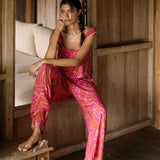 A woman with dark hair wears a YIREH wide legged pant with elastic waistband. It is the Elodi Pant in the Garden 'Awapuhi print. 