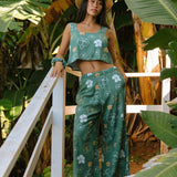 woman wearing lush green square neck crop top with puakenikeni print