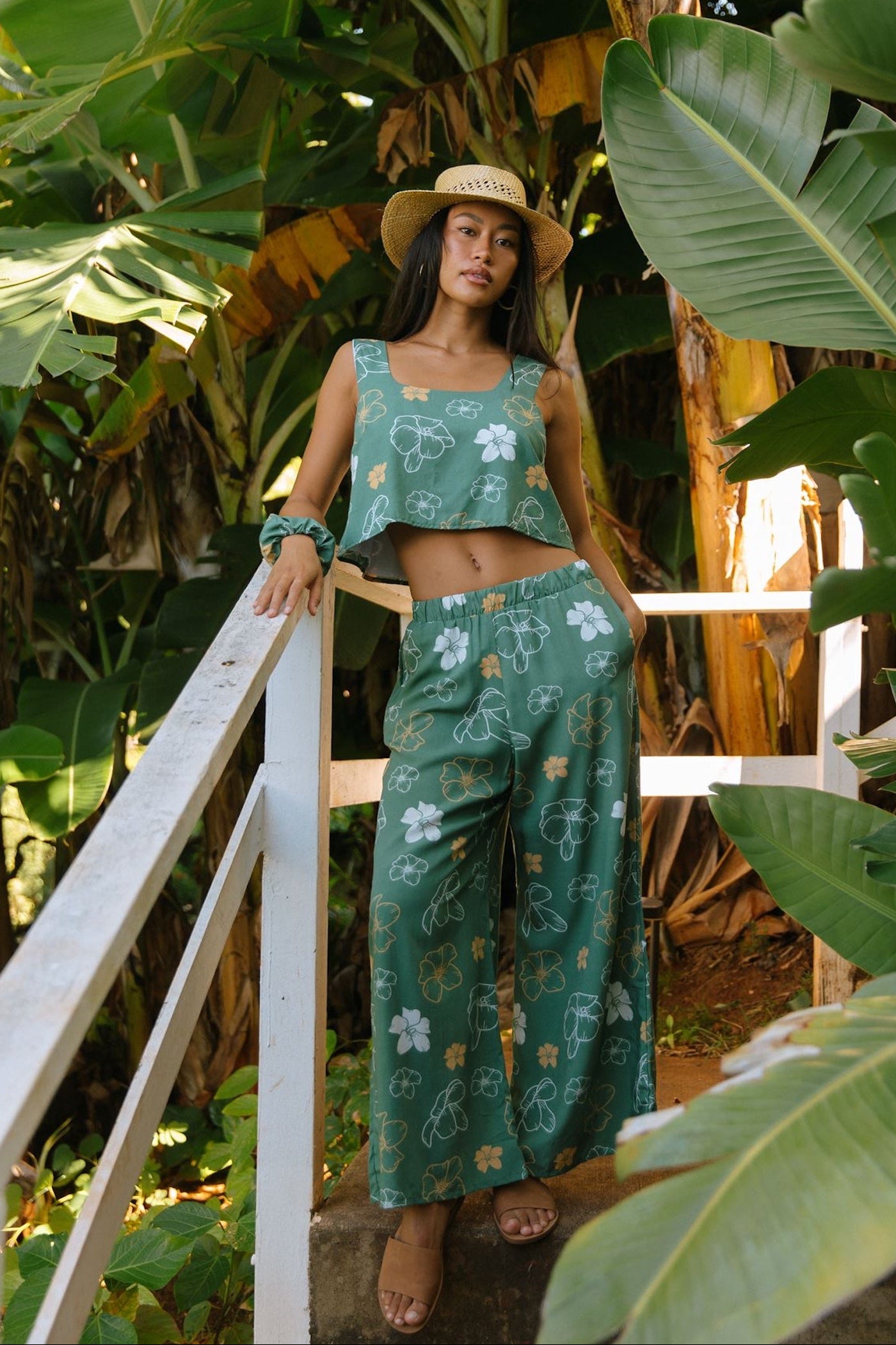 woman wearing lush green square neck crop top with puakenikeni print