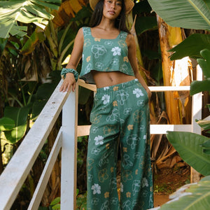 woman wearing lush green square neck crop top with puakenikeni print