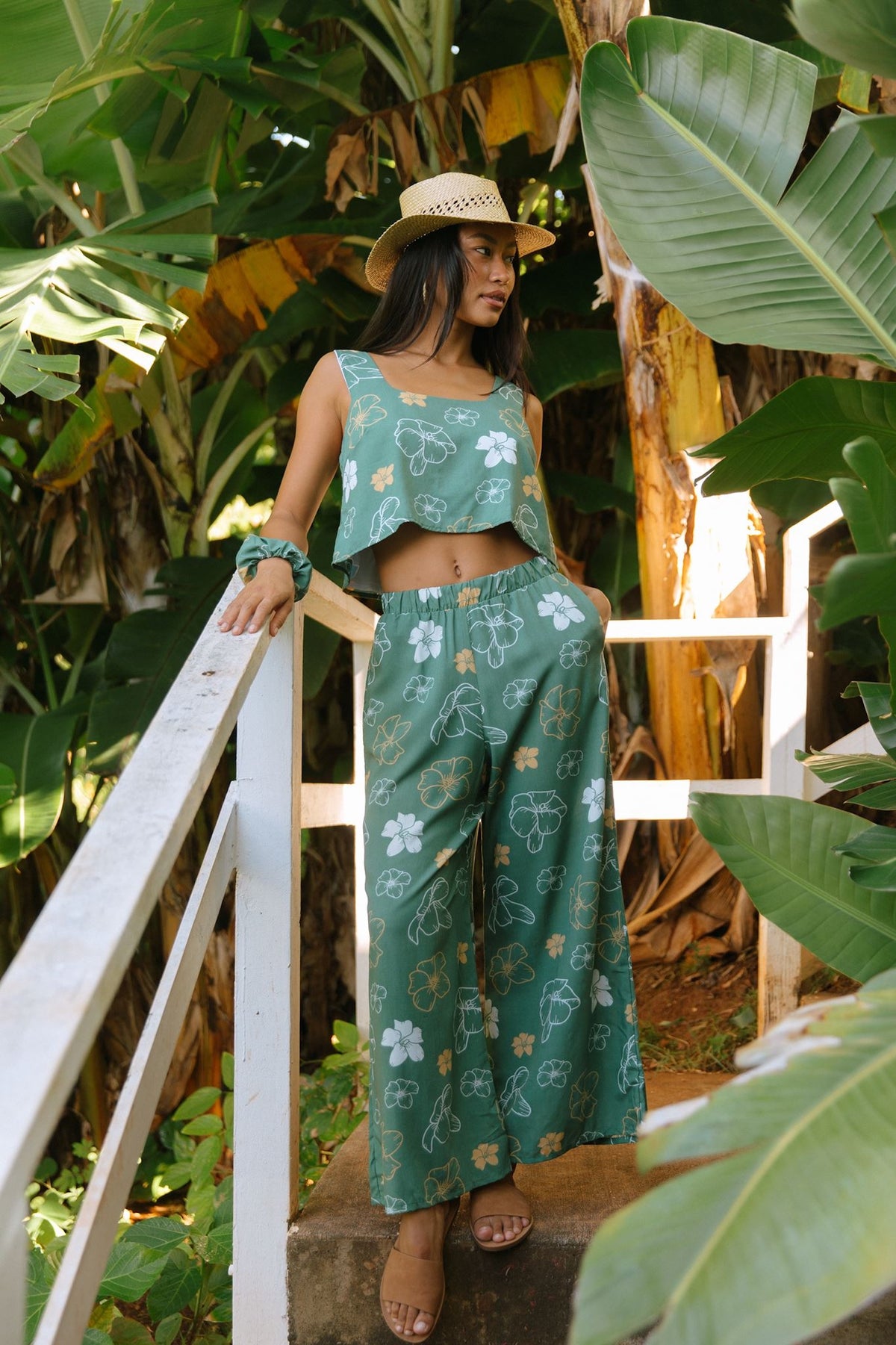 woman wearing lush green square neck crop top with puakenikeni print