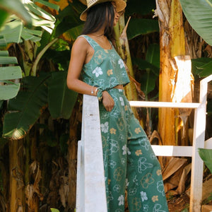 woman wearing lush green square neck crop top with puakenikeni print
