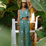 woman wearing lush green square neck crop top with puakenikeni print