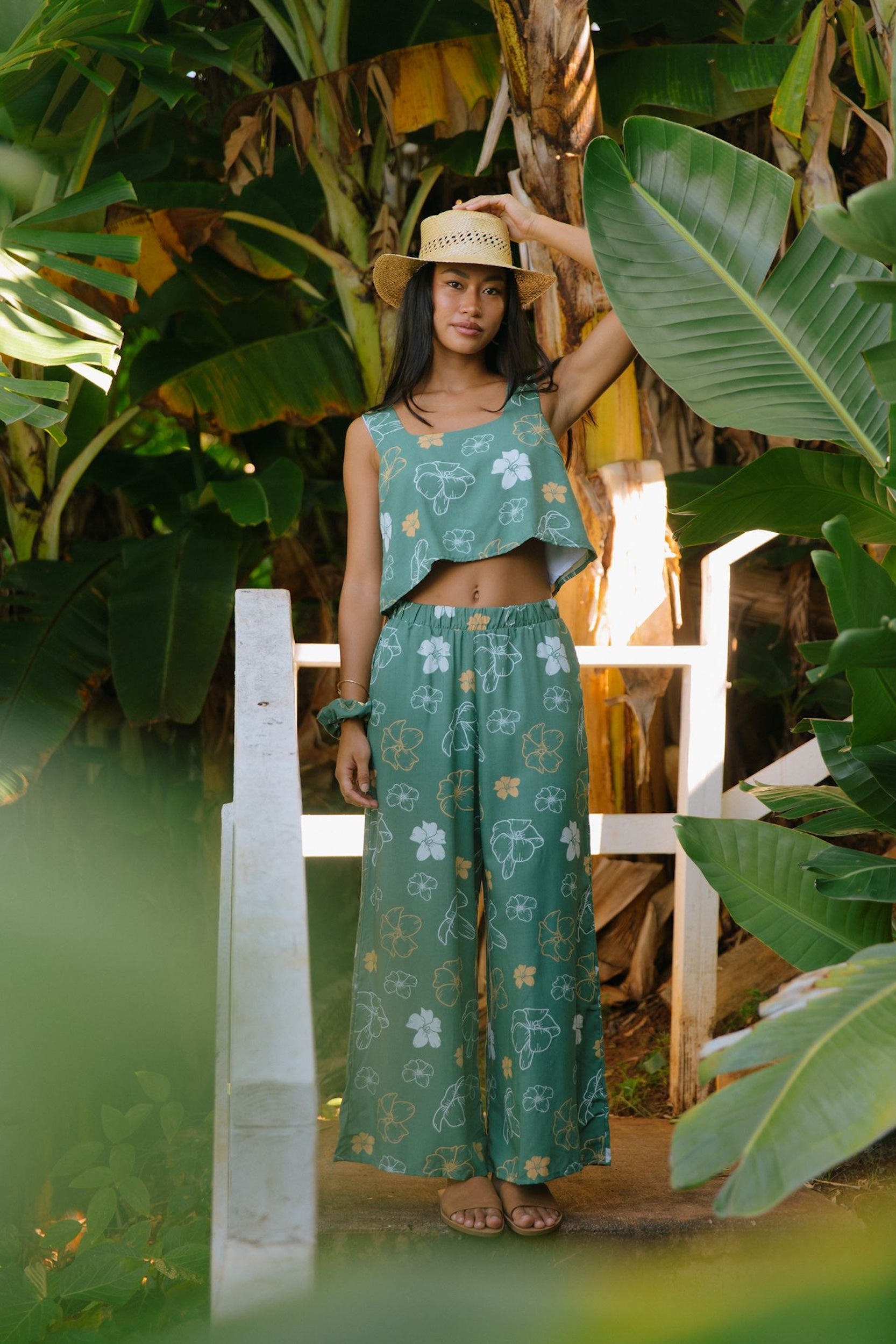 woman wearing lush green square neck crop top with puakenikeni print