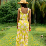 woman wearing a bright green orchid print maxi skirt with matching top