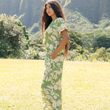 woman wearing green matching top and pant set with native Hawaiian plants 