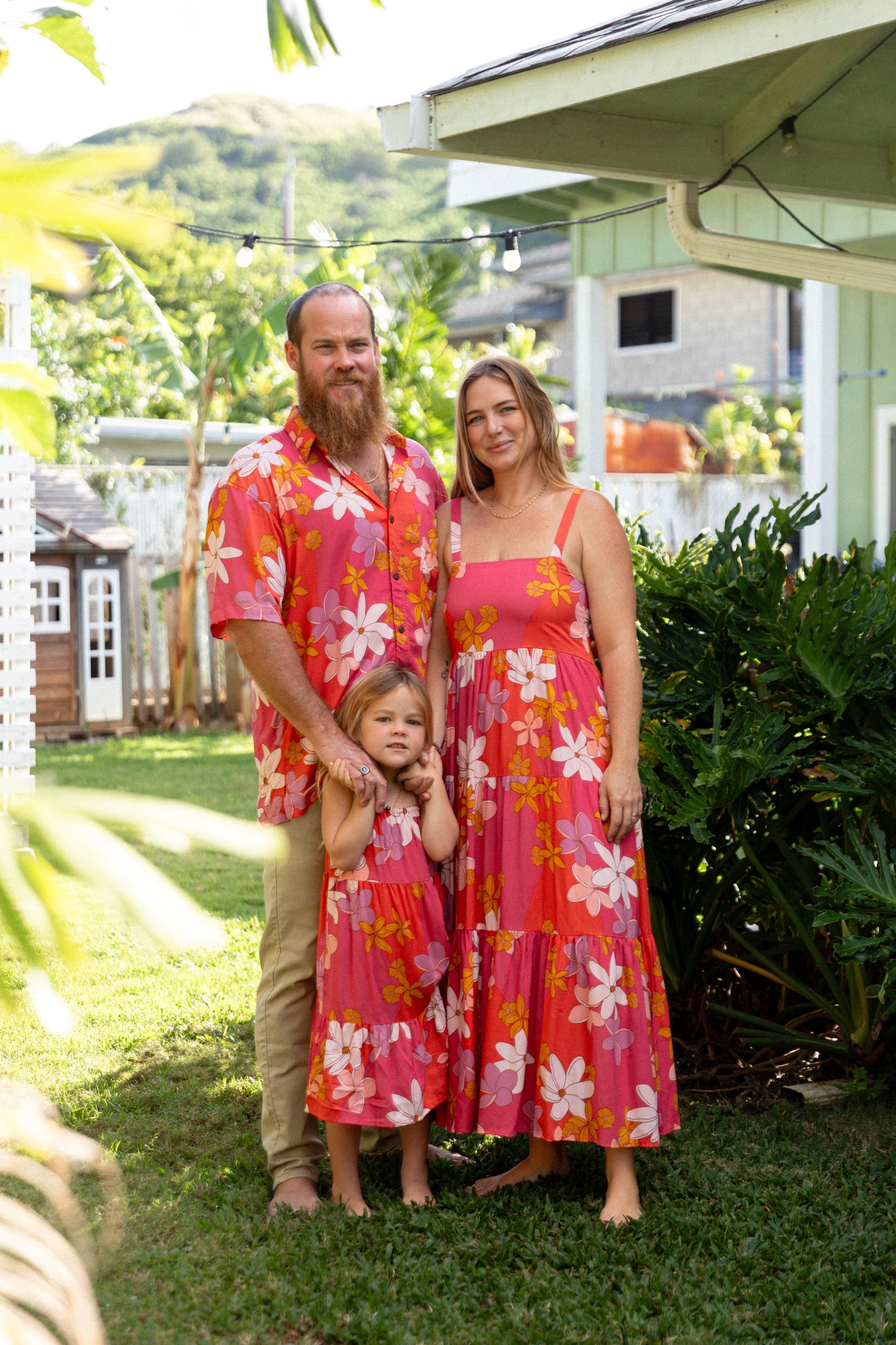 man wearing pink aloha button up shirt with retro flower pattern