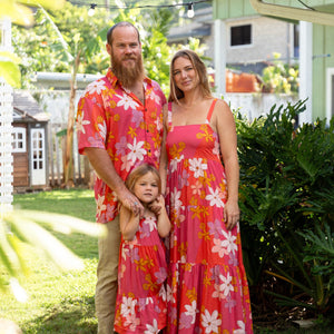 man wearing pink aloha button up shirt with retro flower pattern