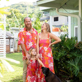 man wearing pink aloha button up shirt with retro flower pattern