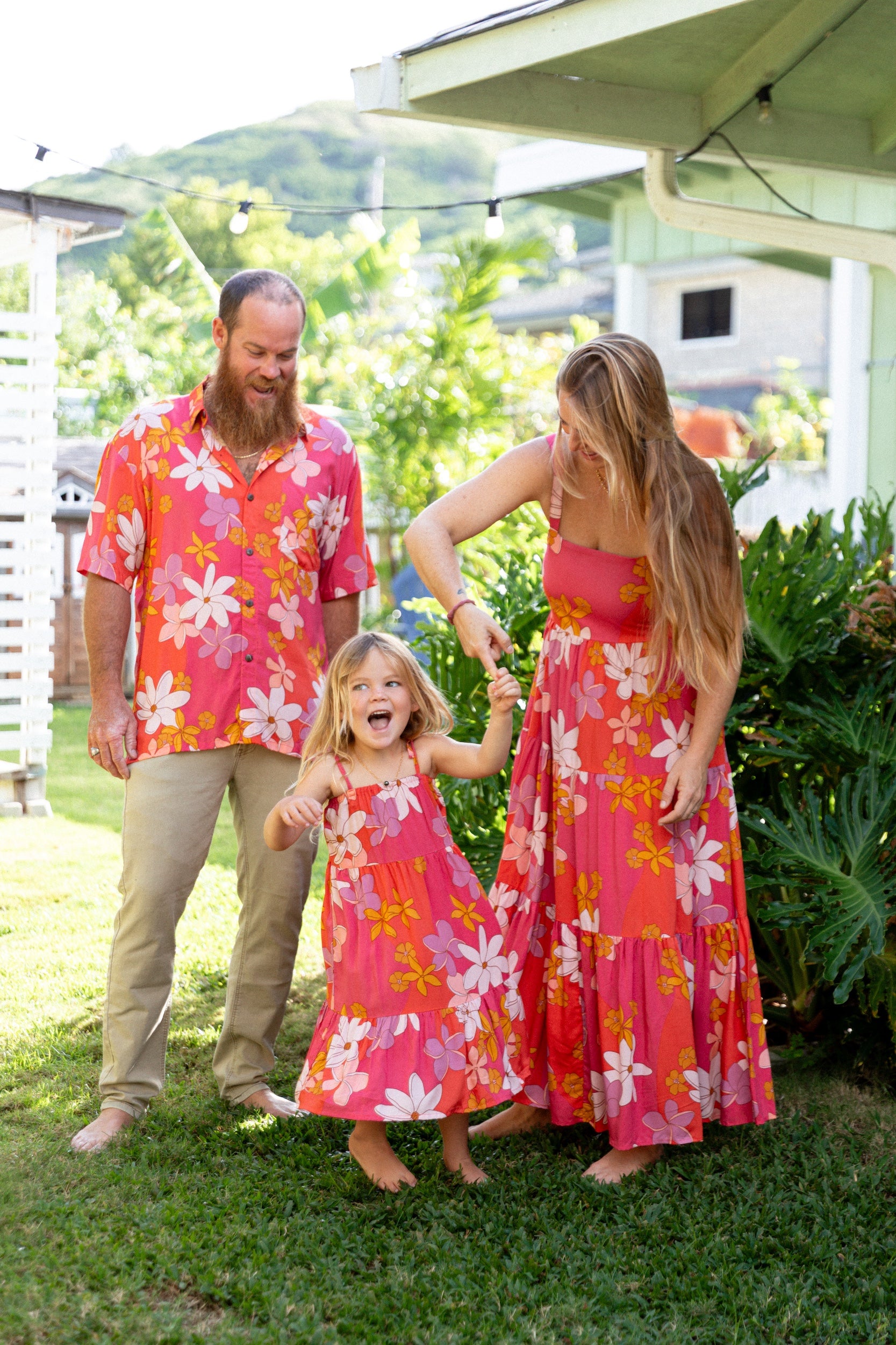 little girl wearing a pink tie strap maxi dress with retro flower pattern
