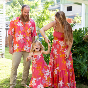 little girl wearing a pink tie strap maxi dress with retro flower pattern