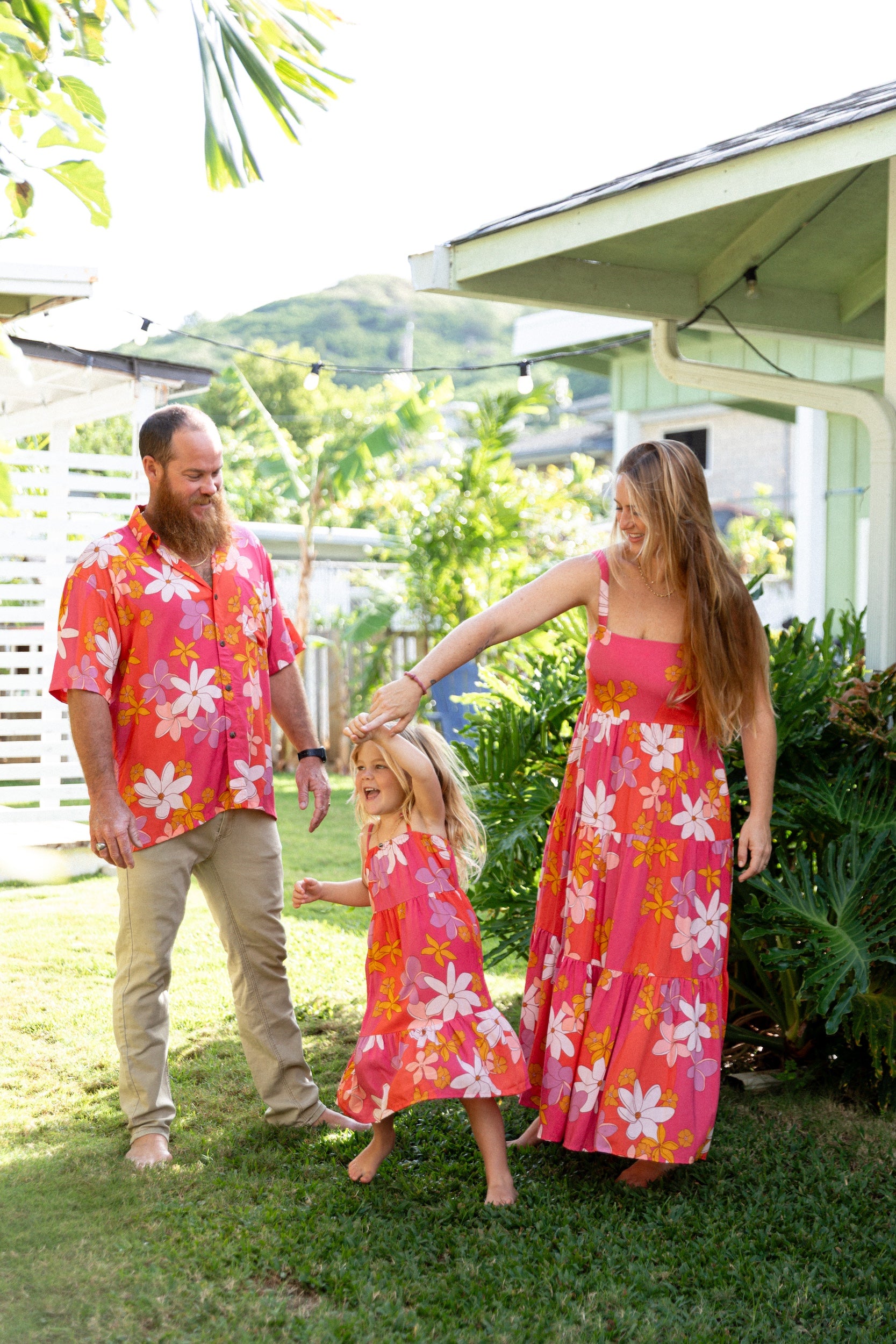 man wearing pink aloha button up shirt with retro flower pattern