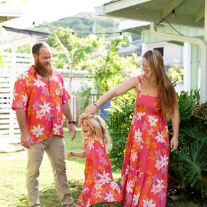 man wearing pink aloha button up shirt with retro flower pattern