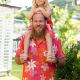 man wearing pink aloha button up shirt with retro flower pattern