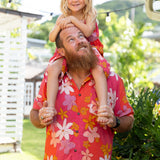 man wearing pink aloha button up shirt with retro flower pattern