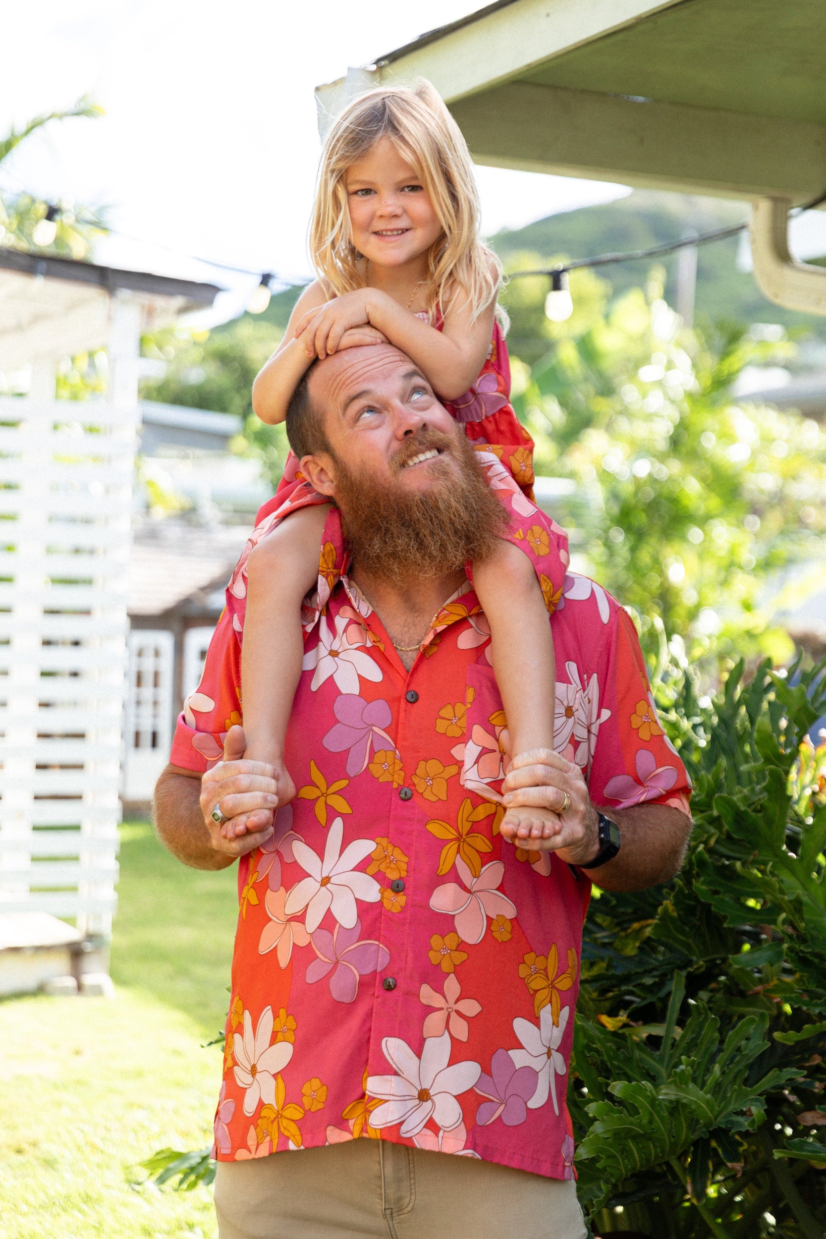 man wearing pink aloha button up shirt with retro flower pattern