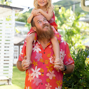 man wearing pink aloha button up shirt with retro flower pattern