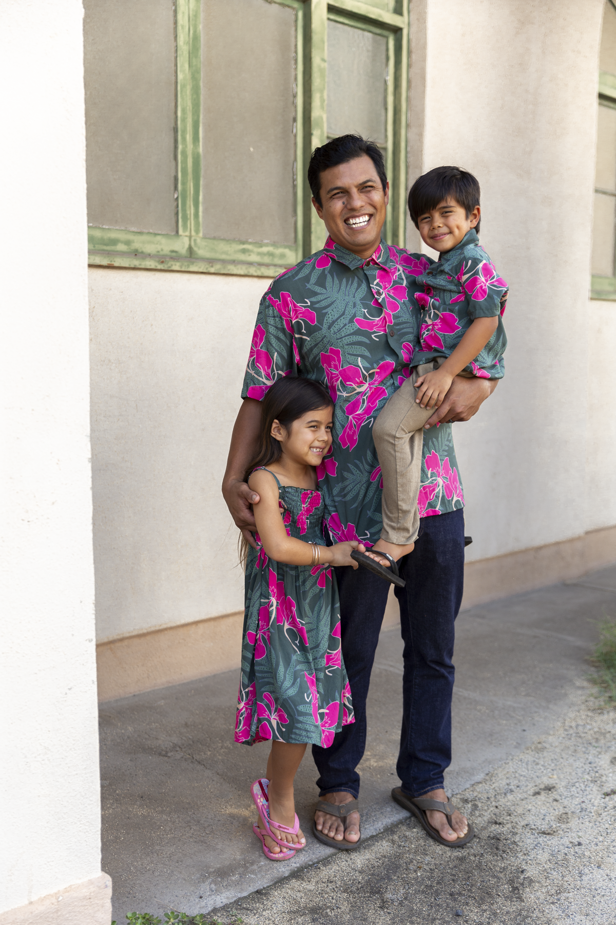 man with brown hair wearing men's aloha button up top with fern and ginger print