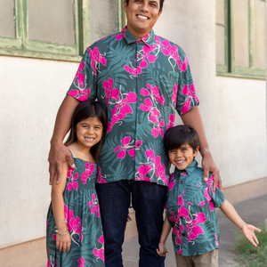 little girl with brown hair wearing a smocked spaghetti strap dress with fern and ginger print