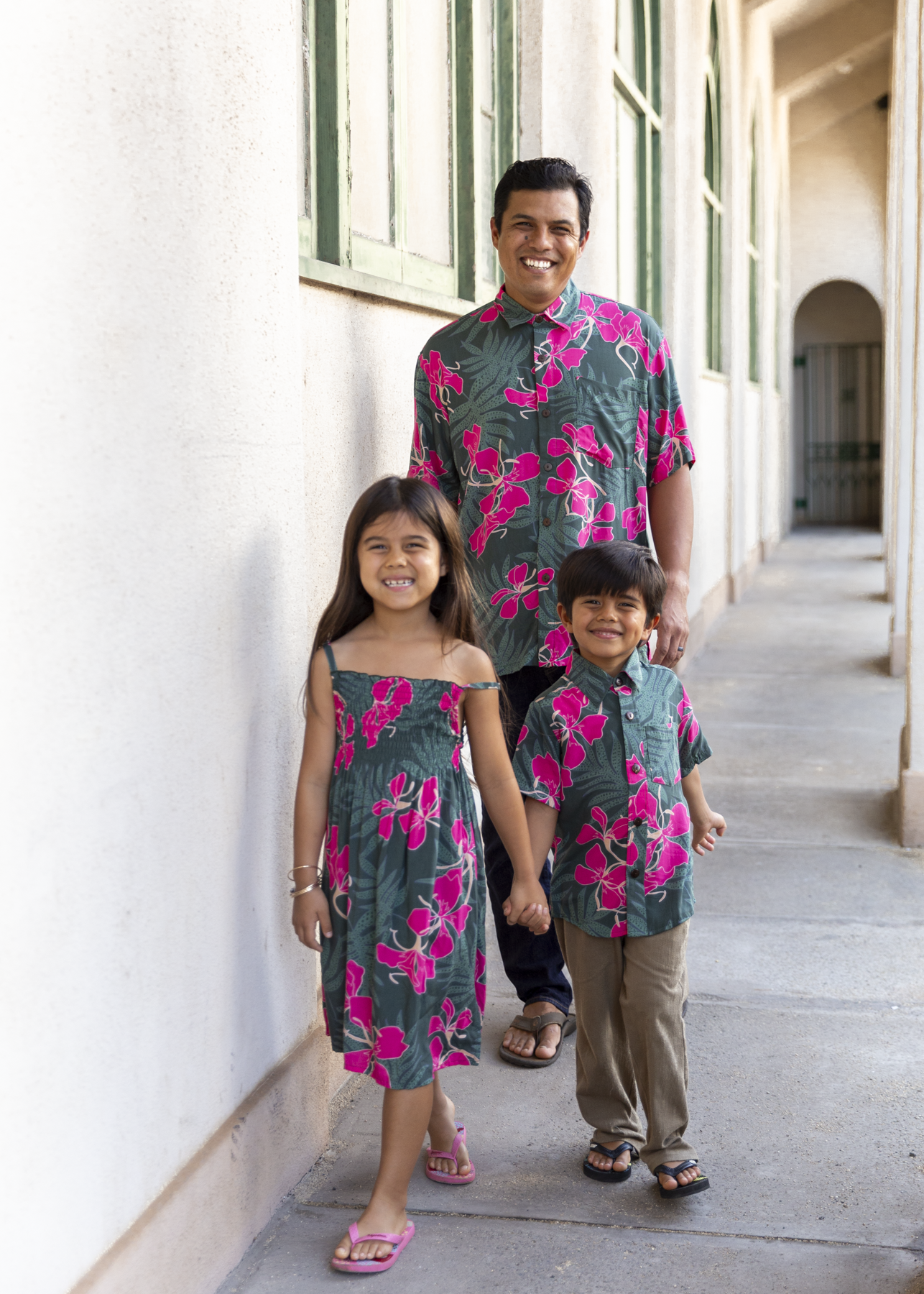 man with brown hair wearing men's aloha button up top with fern and ginger print