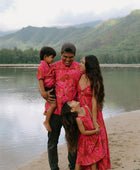 Family in brown aloha attire with large pink floral print