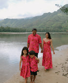 Family in brown aloha attire with large pink floral print