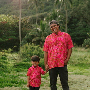 Man and boy in brown button up shirt with large pink floral print