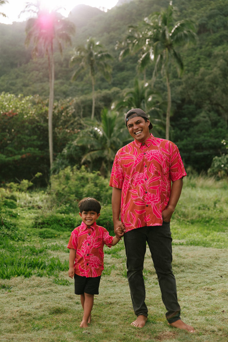 Man and boy in brown button up shirt with large pink floral print