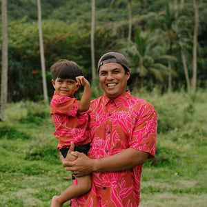 Man and boy in brown button up shirt with large pink floral print
