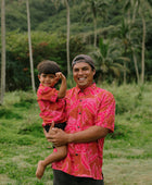 Man and boy in brown button up shirt with large pink floral print