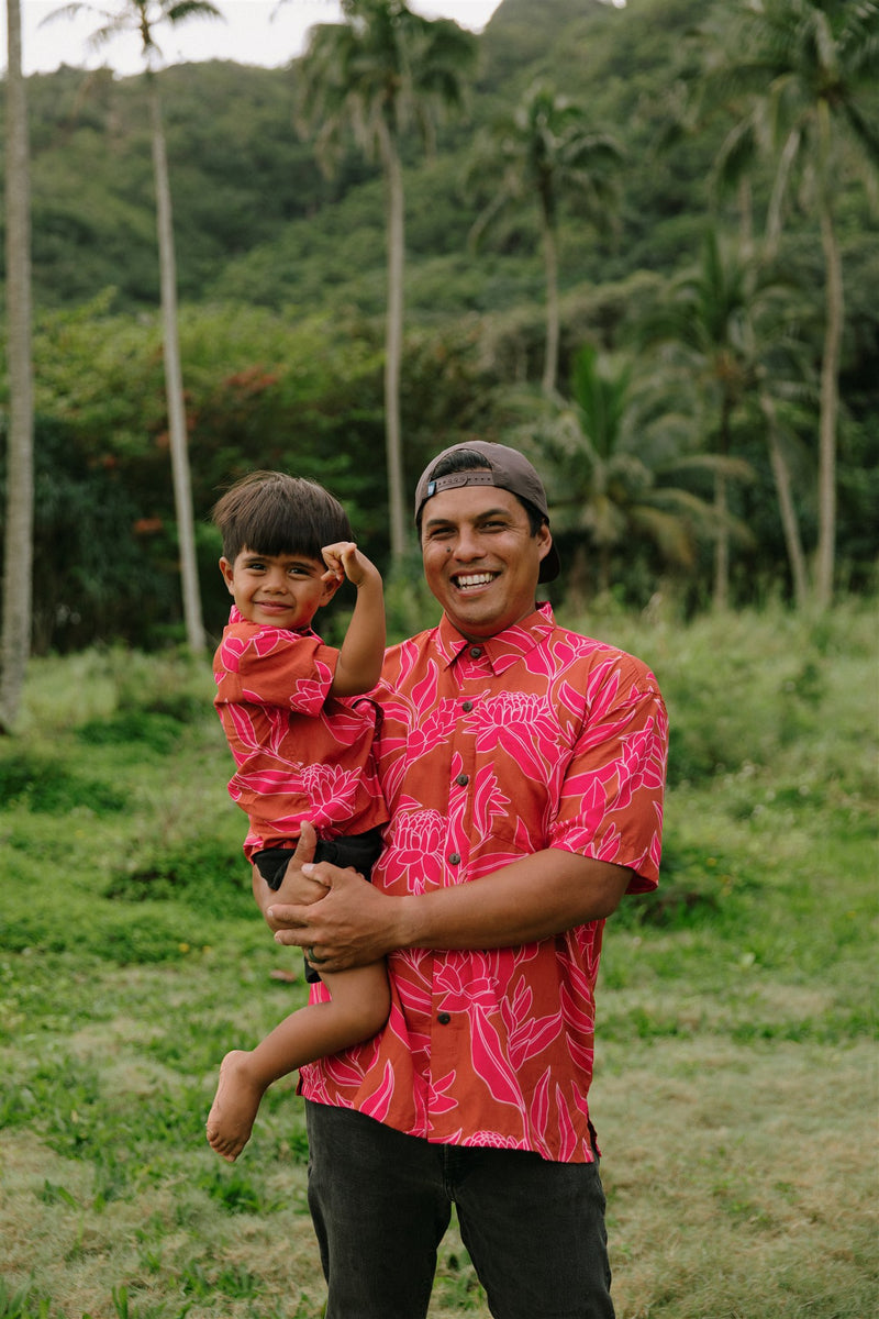 Man and boy in brown button up shirt with large pink floral print