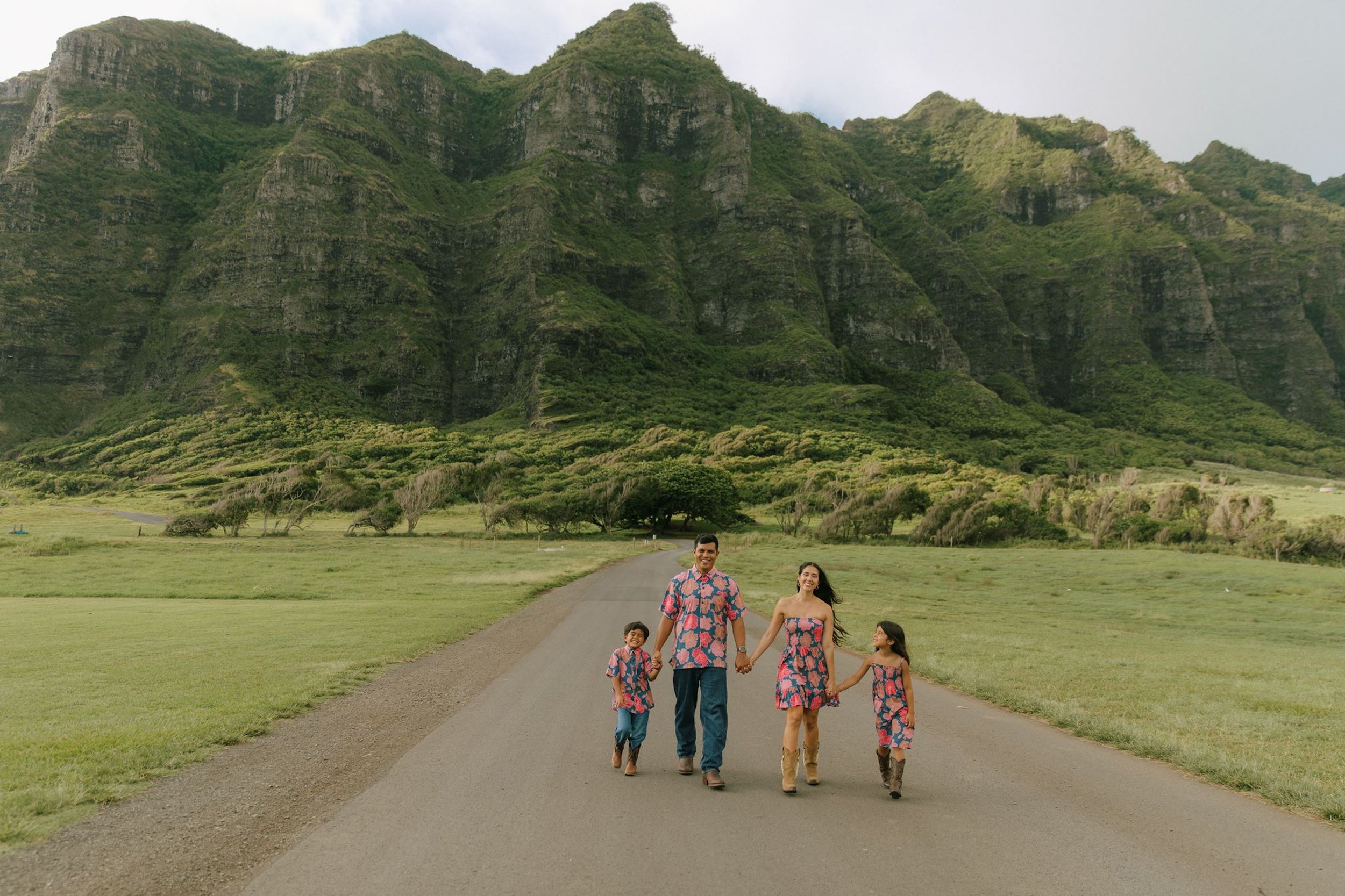 man wearing a nay button up aloha shirt with bright pink hibiscus print