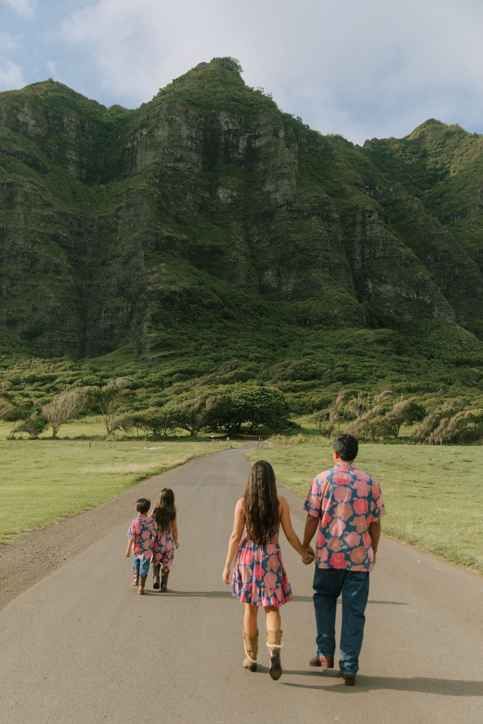 man wearing a nay button up aloha shirt with bright pink hibiscus print
