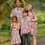 family wearing matching teal aloha wear with floral print