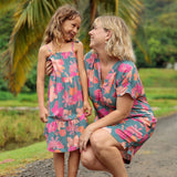 family wearing matching teal aloha wear with floral print