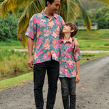 family wearing matching teal aloha wear with floral print