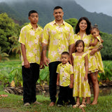 family wearing matching bright green aloha wear with orchid print