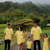 family wearing matching bright green aloha wear with orchid print
