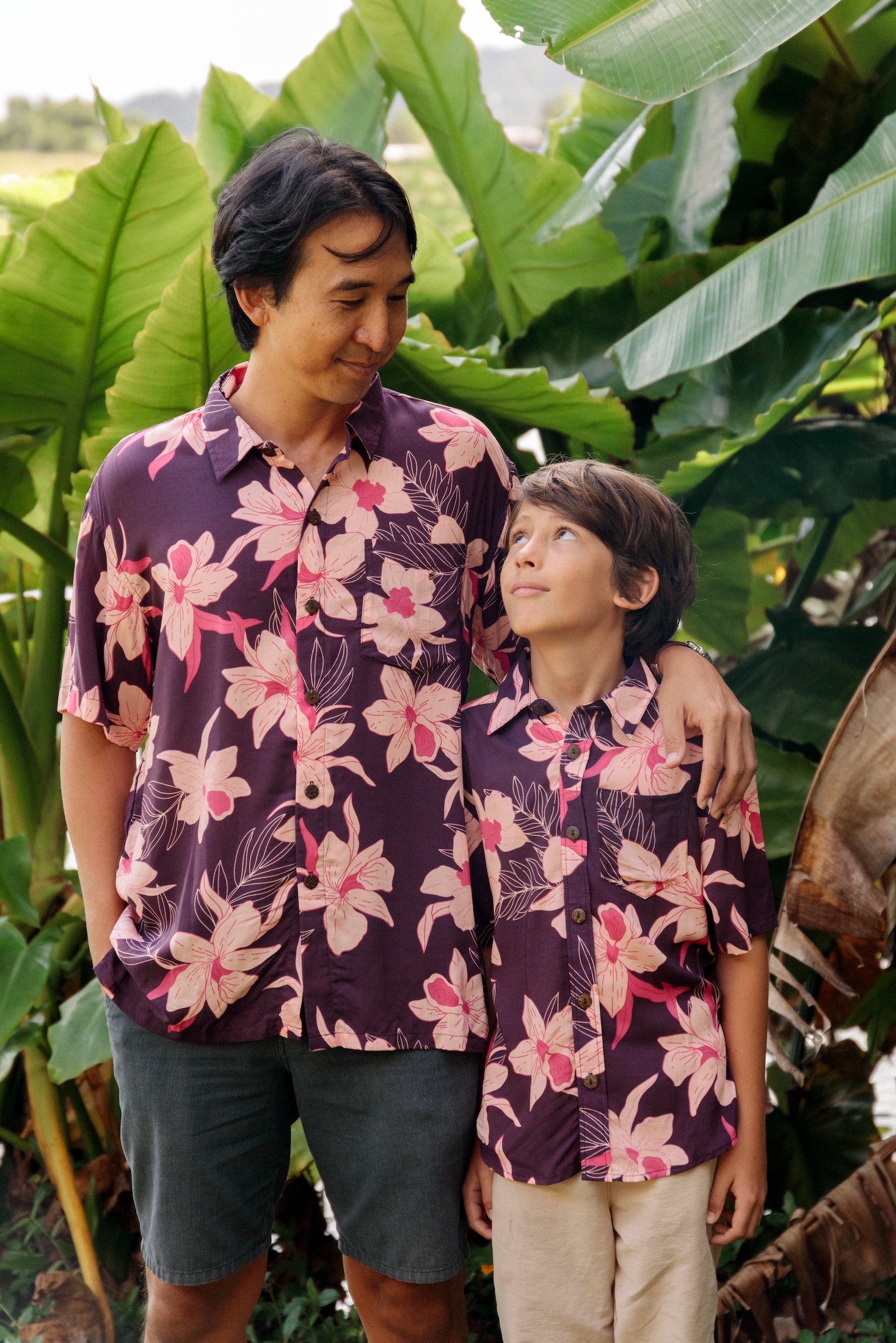man wearing dark purple aloha shirt with orchid print