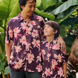 man wearing dark purple aloha shirt with orchid print