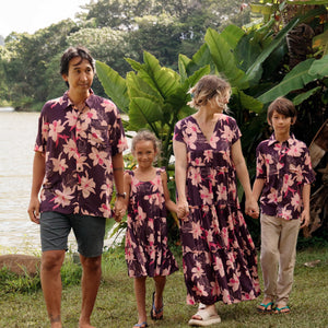 man wearing dark purple aloha shirt with orchid print