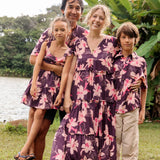man wearing dark purple aloha shirt with orchid print